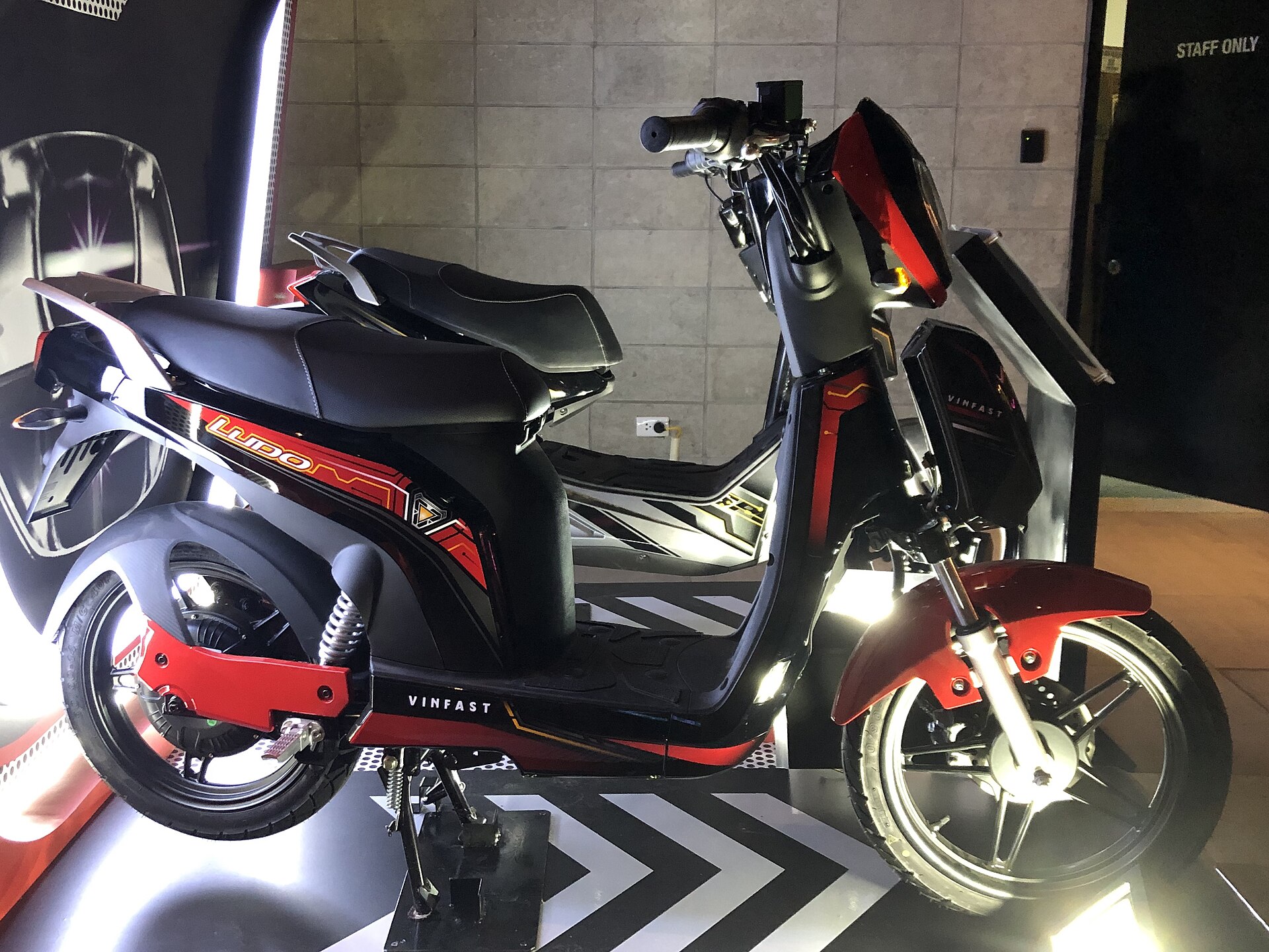 A modern VinFast electric scooter on display at a launch event